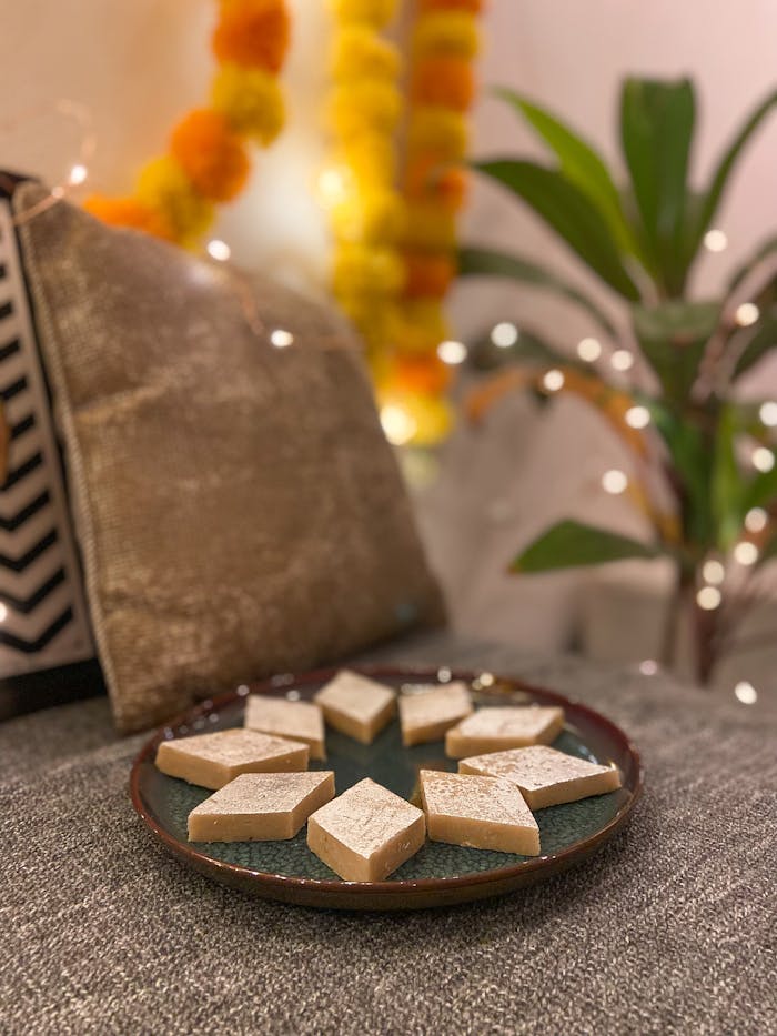 services-01 Plate of Kaju Katli sweets with festive decor in Mumbai, India.