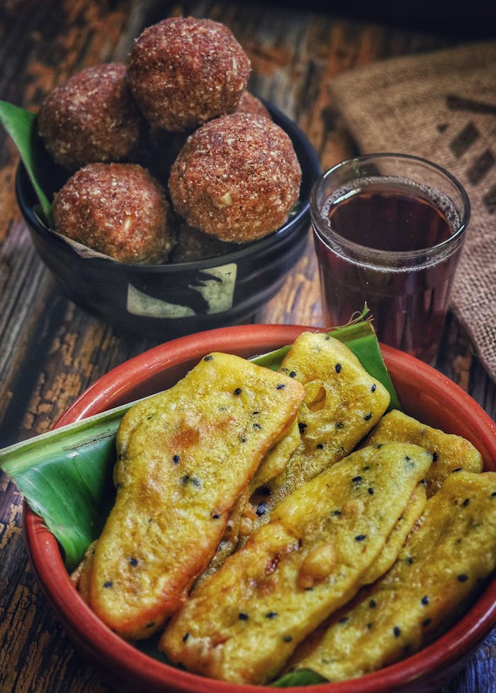 Close-up of Indian banana fritters and snacks in bowls, perfect for food photography.